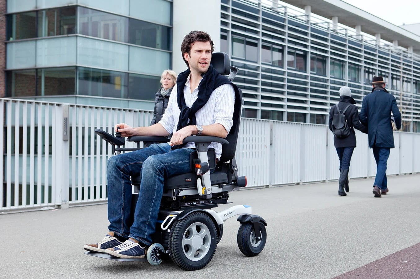 A man who is sat in his wheelchair, he has a complete (paraplegia) spinal cord injury