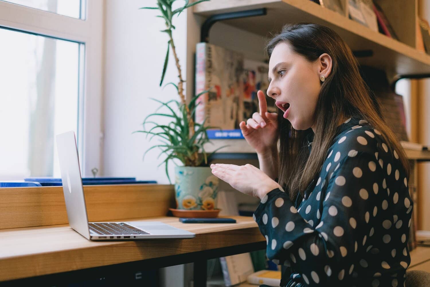 Picture of a lady with a laptop in front of her reading about counselling adults with disabilities