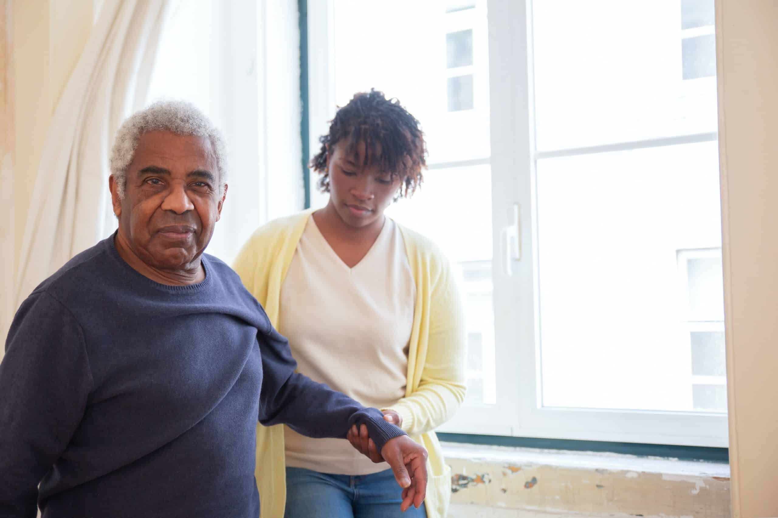 Lady hold the arm of a man, the picture represents carer counselling